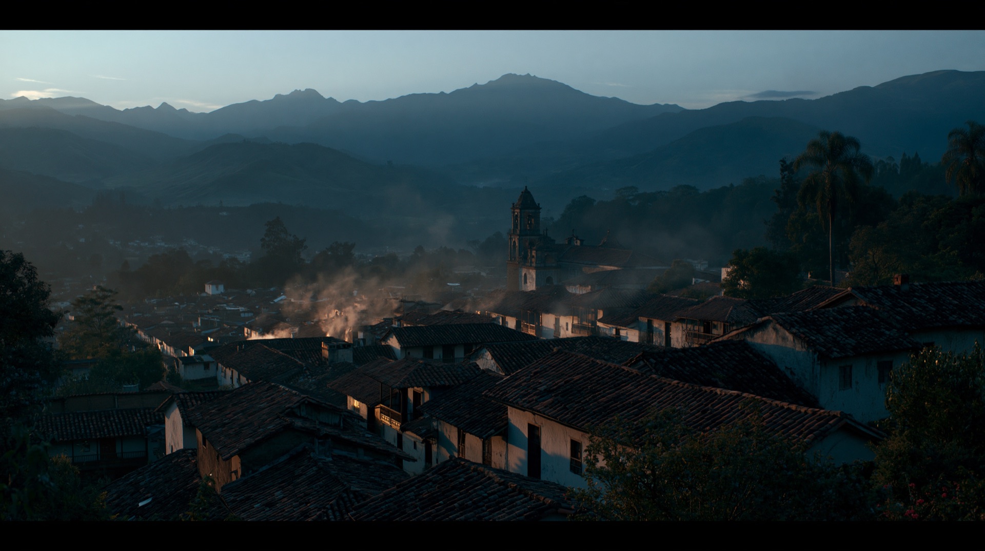 Colombian mountain town at dusk, mist and tiled roofs