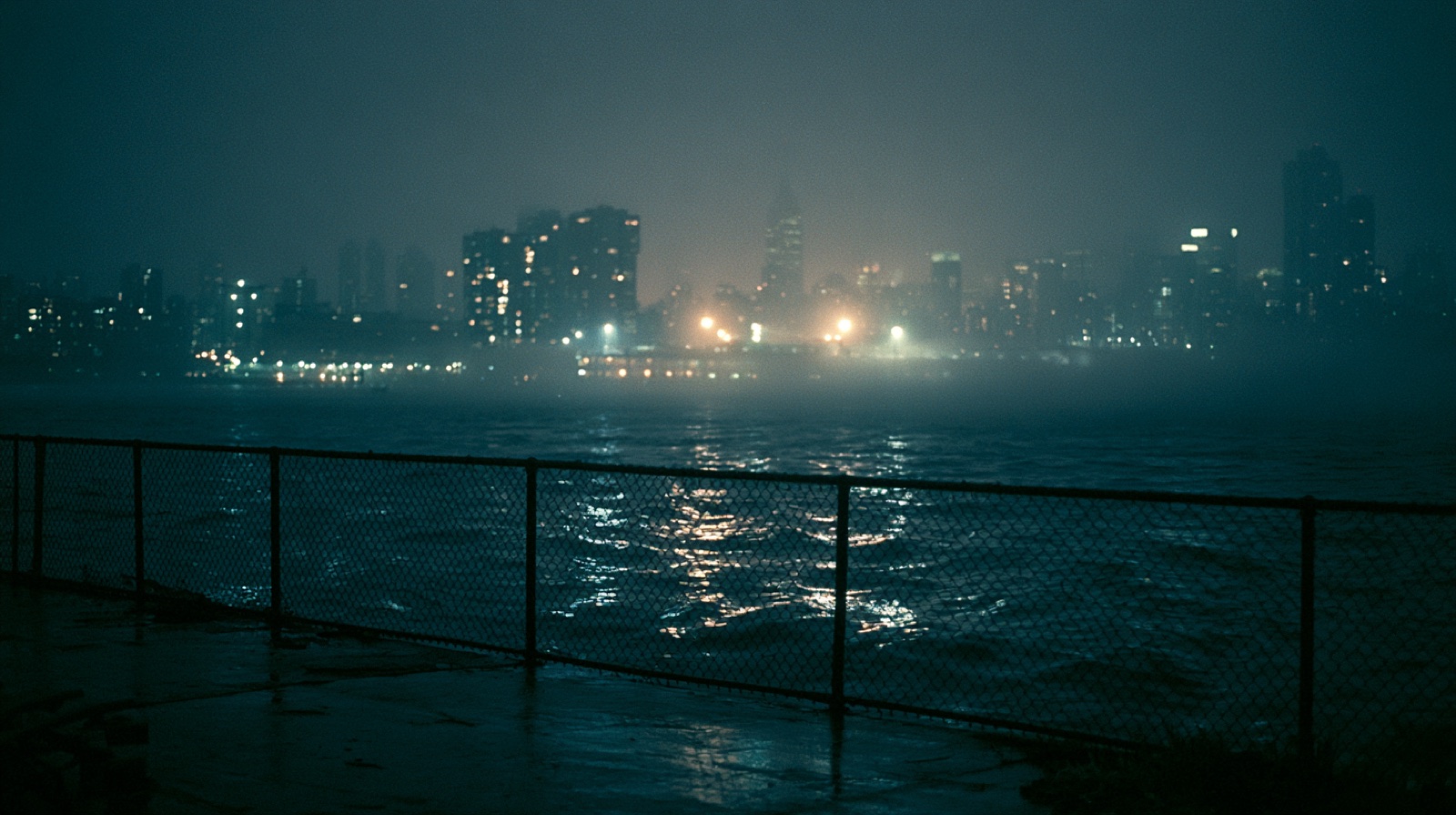 Foggy skyline across the water at night